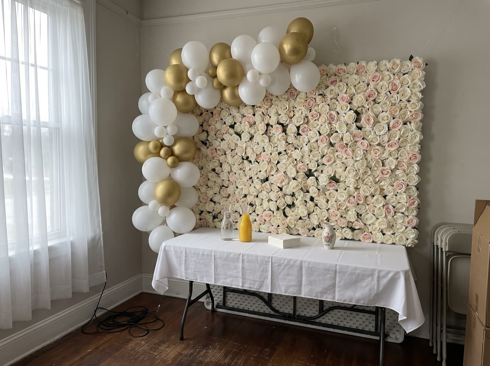 Flower wall backdrop with a white and gold balloon garland