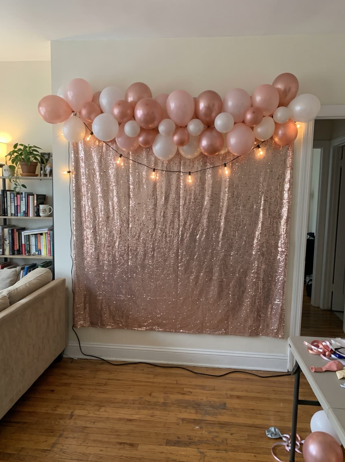 Rose gold shimmer wall with a blush balloon garland