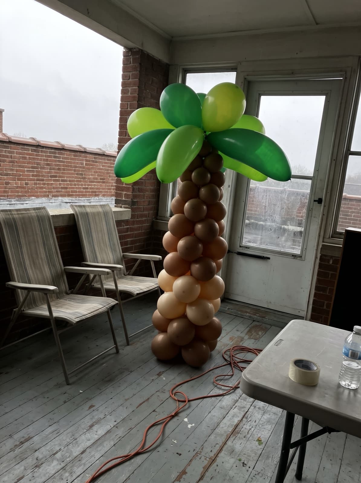 Palm tree balloon column on a rooftop deck