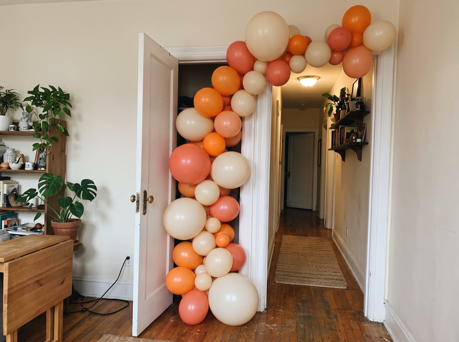 Organic balloon garland around an apartment doorway