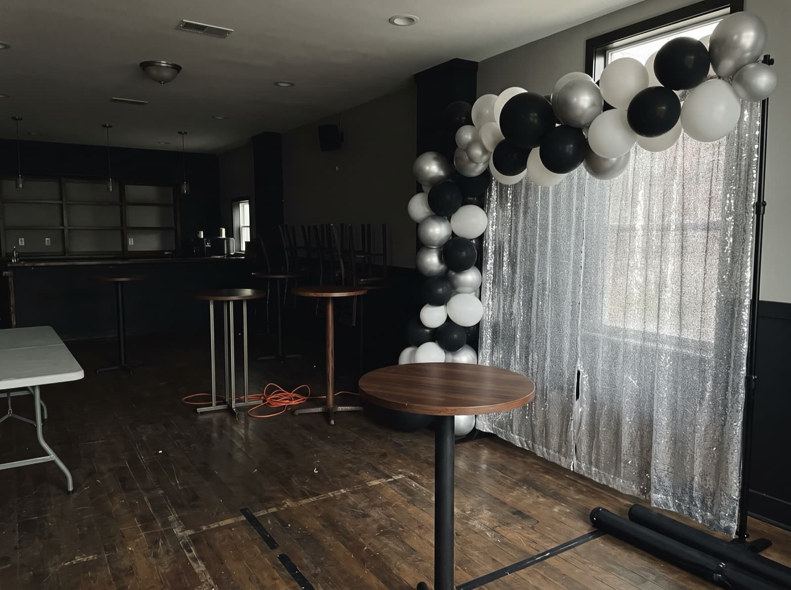 Balloon garland over a silver shimmer wall in a lounge
