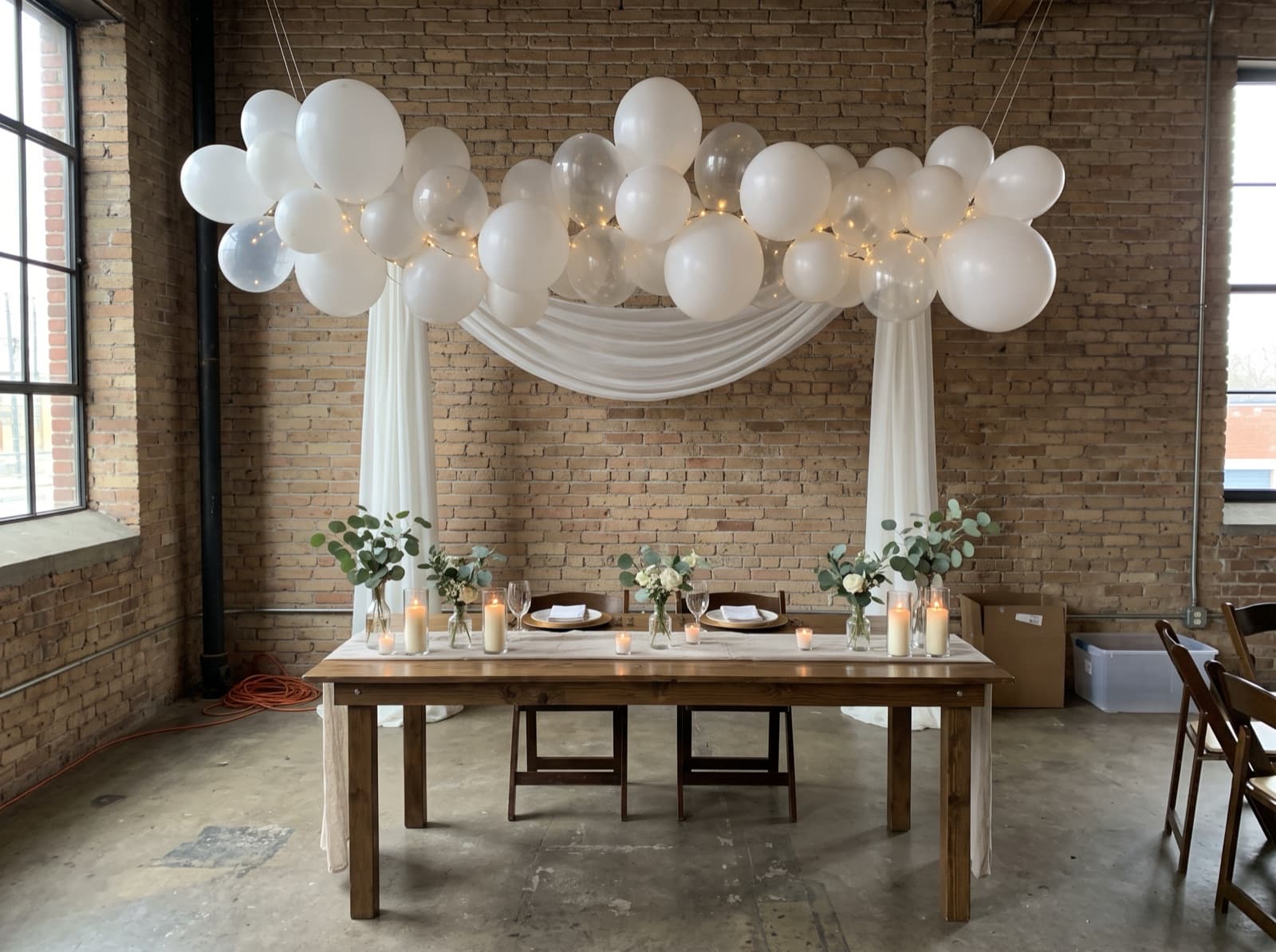 Balloon cloud over a sweetheart table in a loft