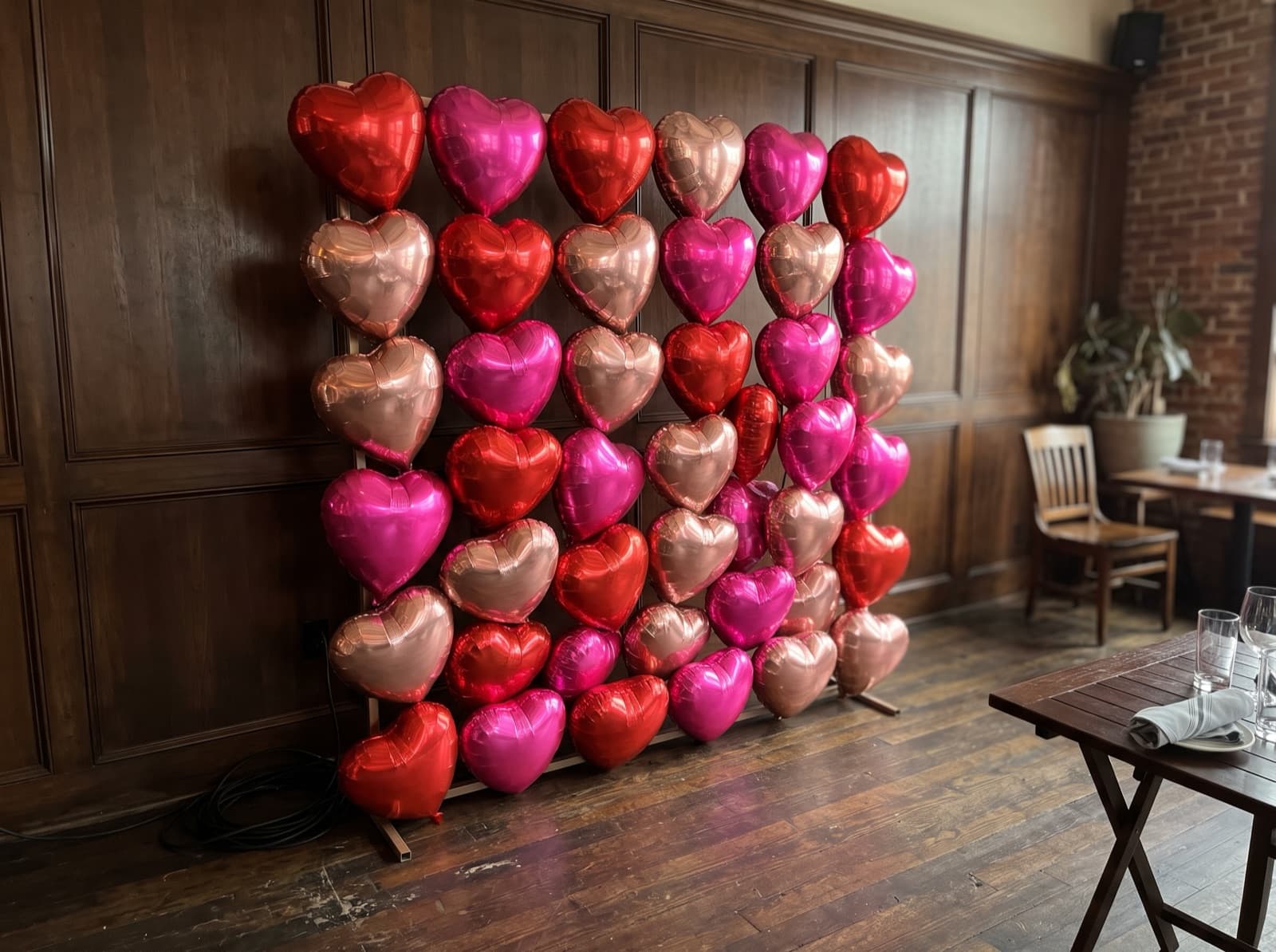 Foil heart balloon wall in red, hot pink and rose gold